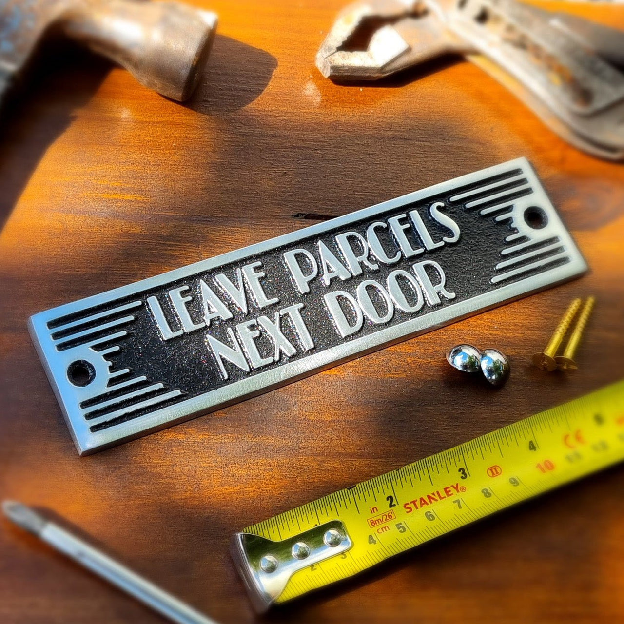 Art Deco 'Leave Parcels Next Door' Door Sign - The Metal Foundry